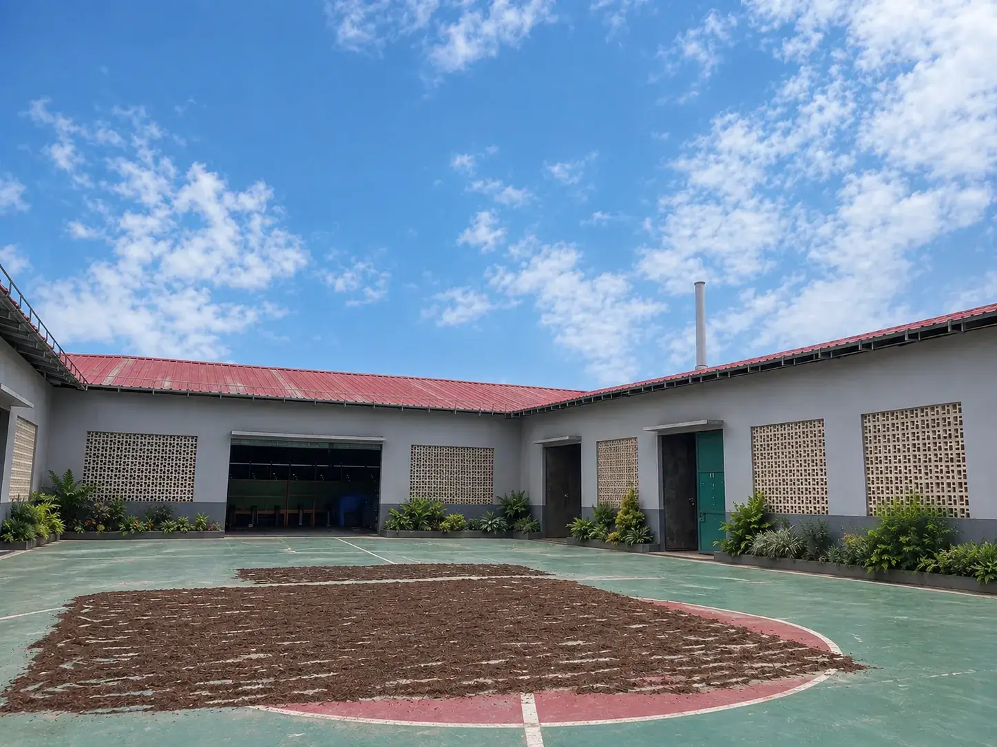 Material laid out to dry across the courtyard between the production sheds.